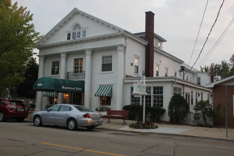 a car parked in front of a white building