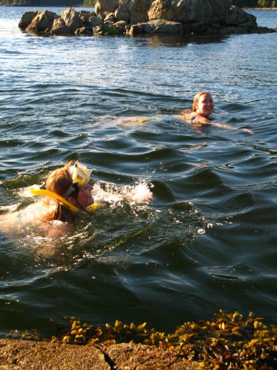 two young people floating in the water on jet skis