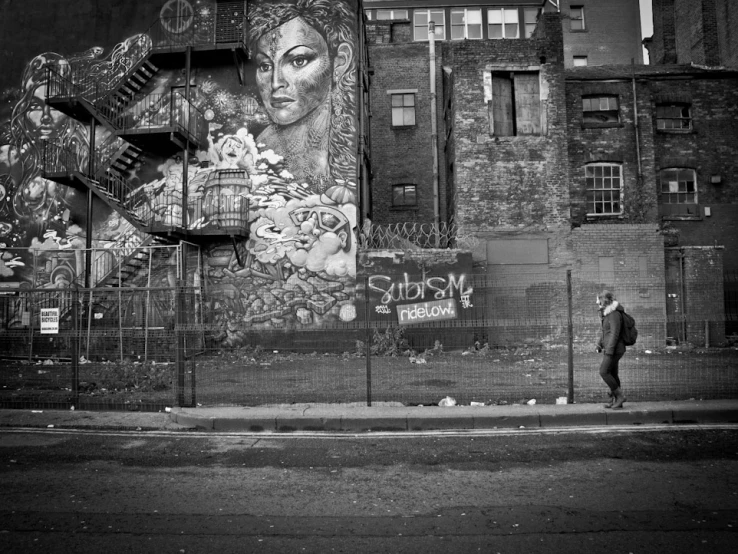 a person is walking by an old building