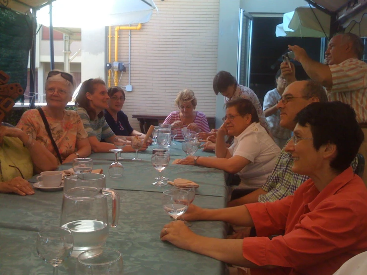 a group of people are sitting around a table