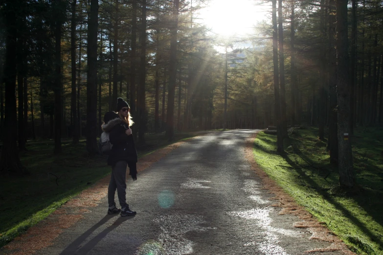 a  is riding his skateboard down the road