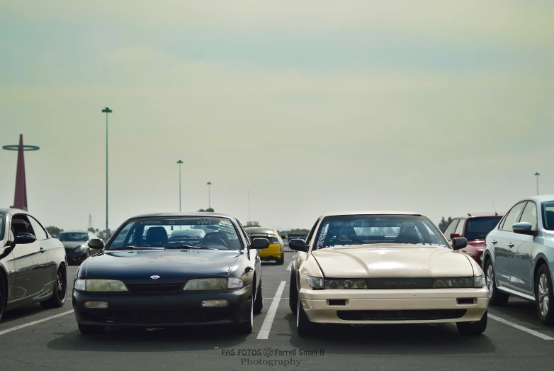 several cars parked in a lot near each other