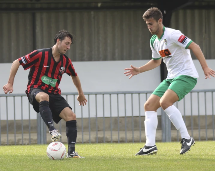 two men playing a game of soccer against each other