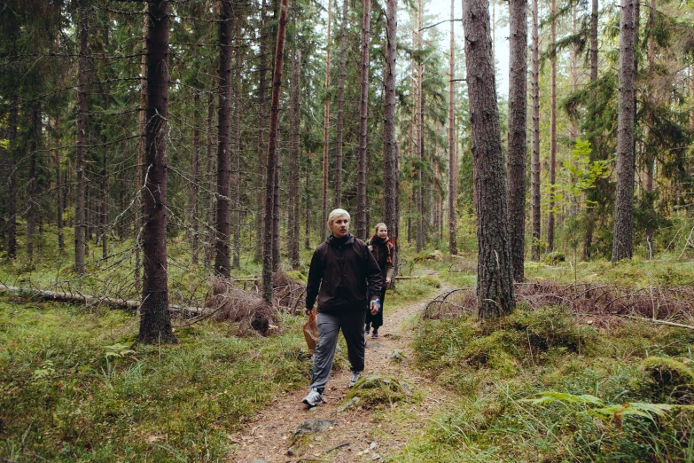 two people are walking in the woods together