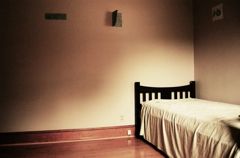 a dark wooden crib in a bedroom