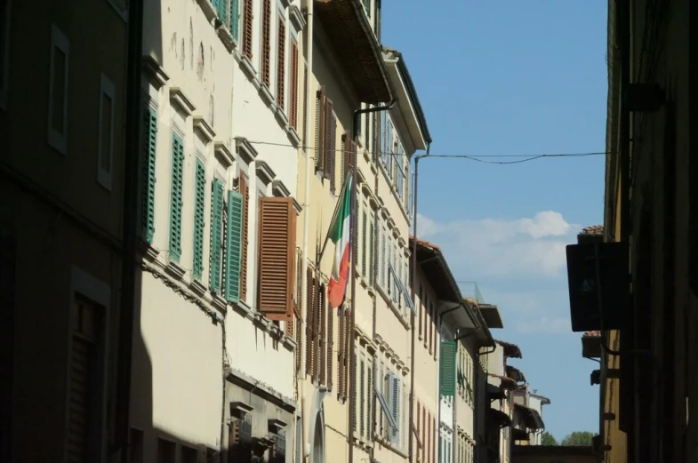 a group of buildings with windows and wooden shutters