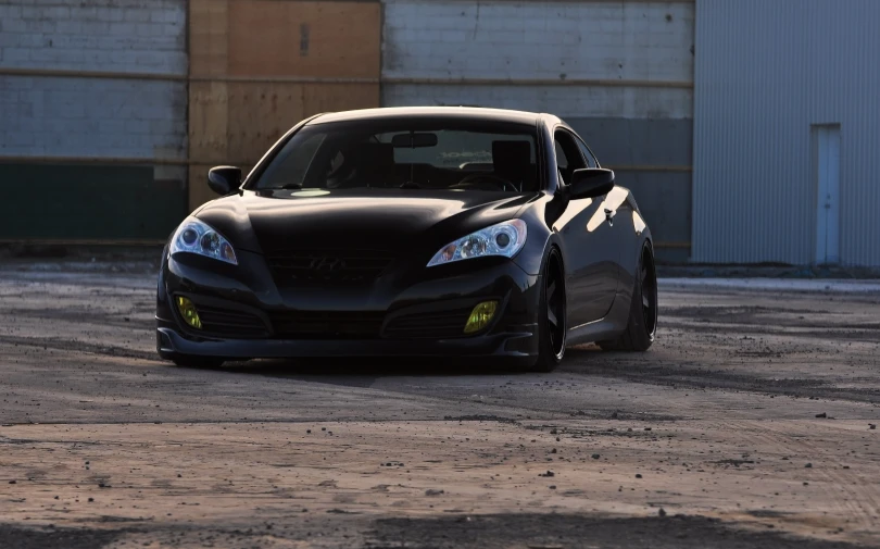 a black sports car driving down the road