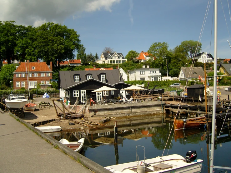 many small sail boats sit in the harbor