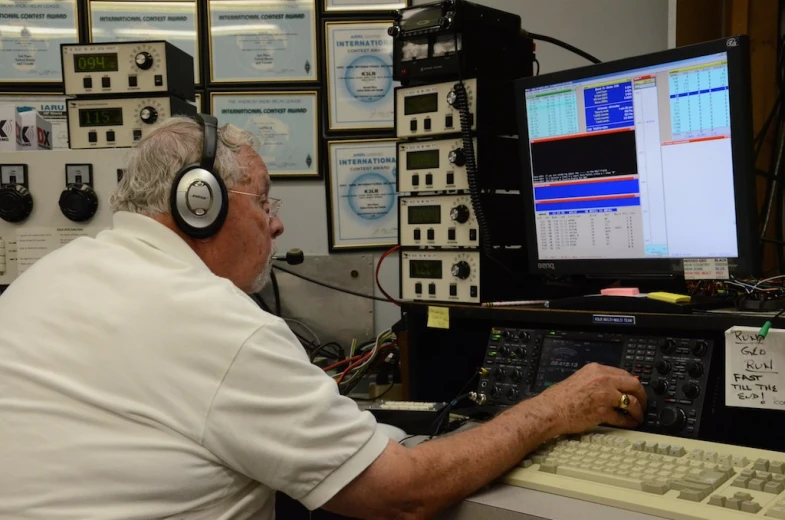 a man with headphones on working at a computer