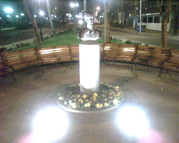 illuminated sculpture on a bench in park at night
