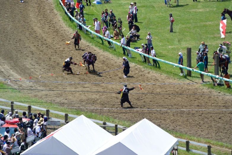 a man on a horse raising his hands in a race