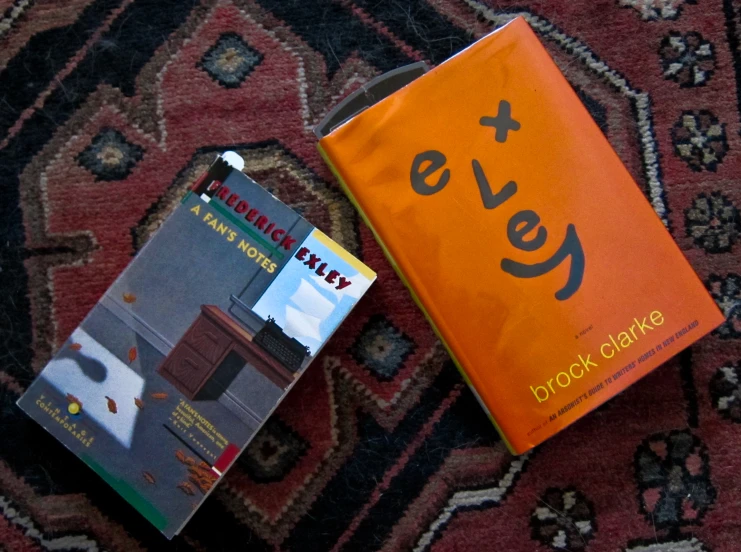 two books that are laying down on a carpet