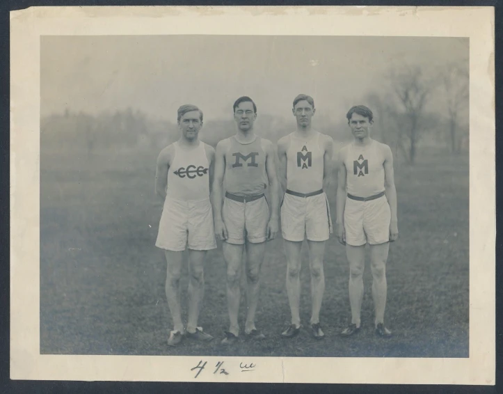 three men standing next to each other in a field