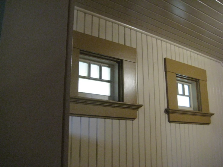 two windows are shown in a tan paint room