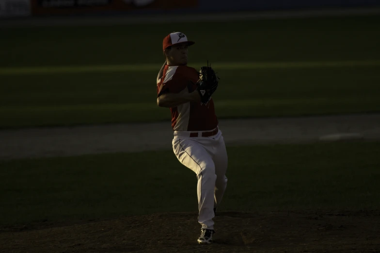 the man on the mound is warming up before he pitch