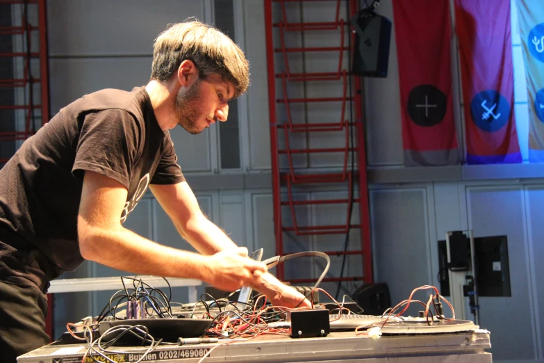 a man in a dark shirt is working on a machine