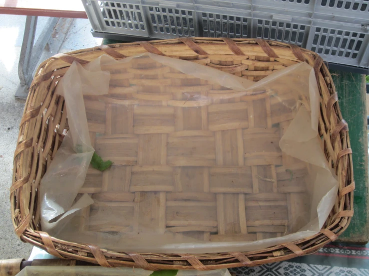 a woven basket with plastic wrap