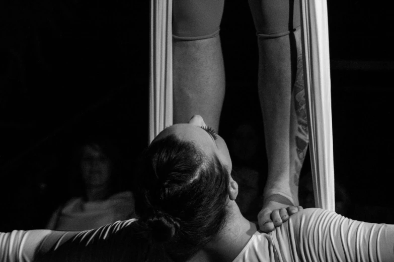 the woman is doing an aerial trick with her hands