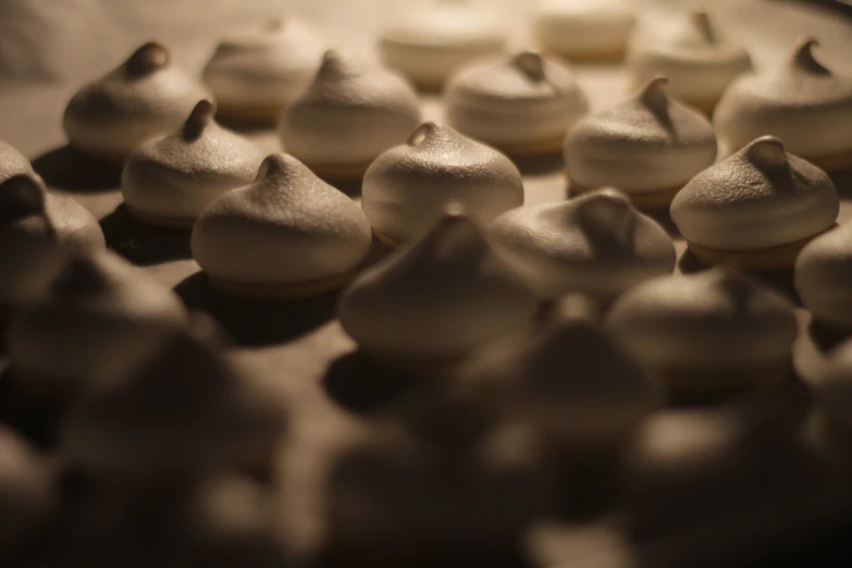 many small cookies are arranged on a tray