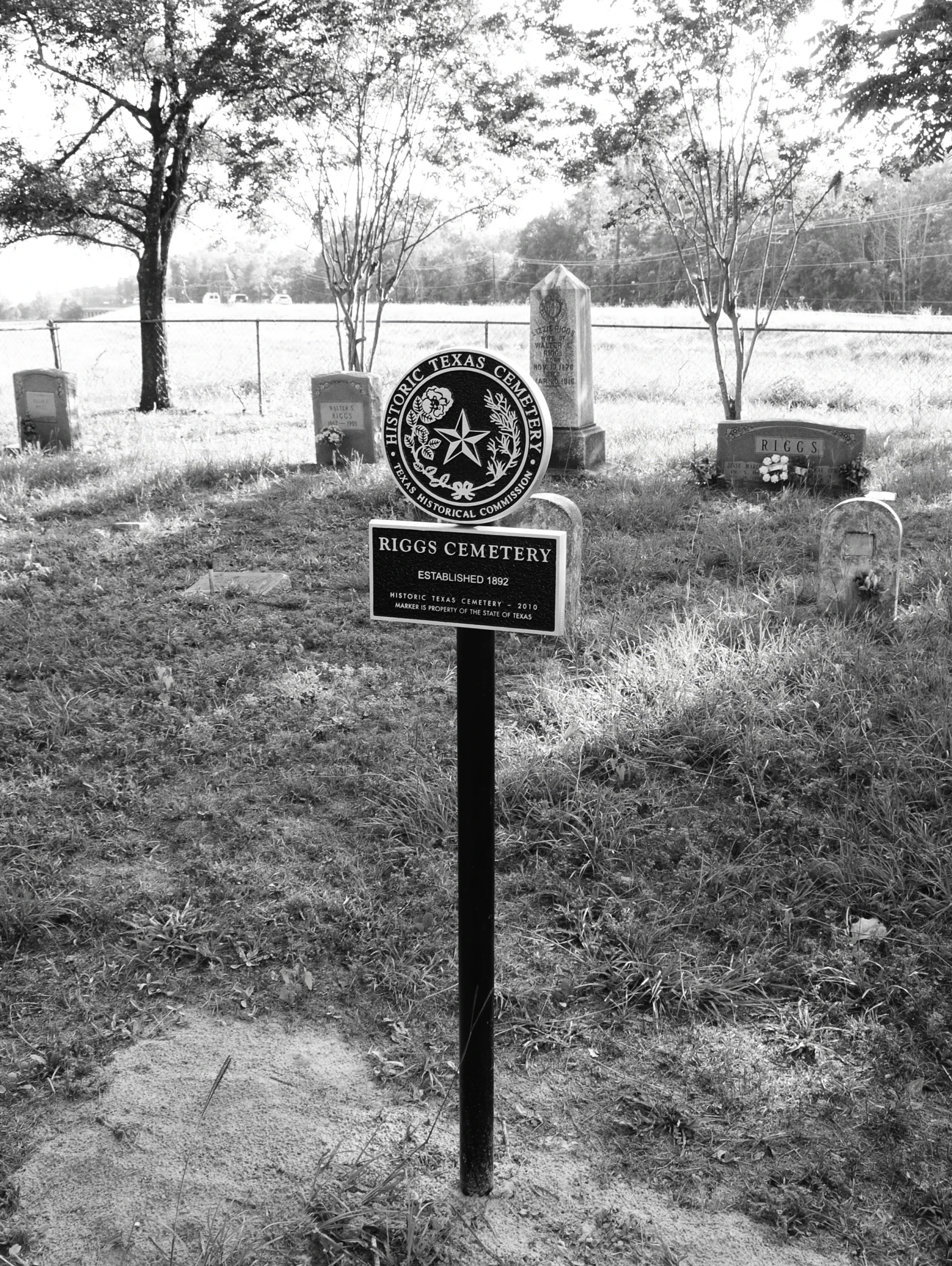 a black and white po of the sign at a cemetery