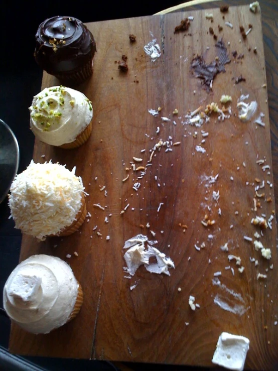 a wooden board topped with lots of desserts