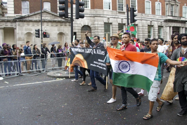 people are holding an indian and indian flag in the street