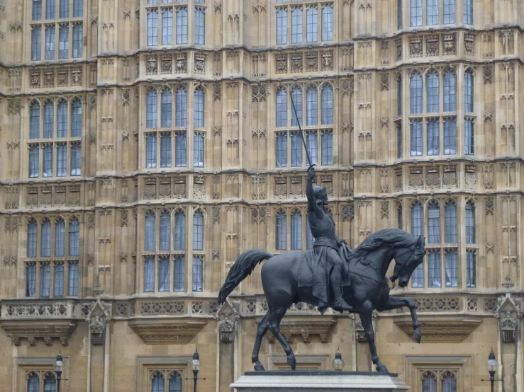 there is a large building with many windows and statues