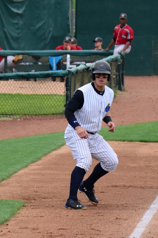 the baseball player is holding a bat near home plate