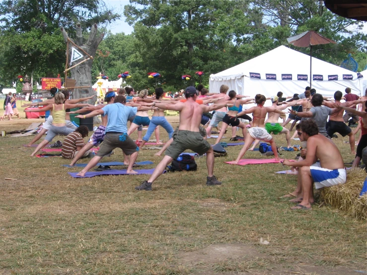 a group of people doing yoga outside during the day