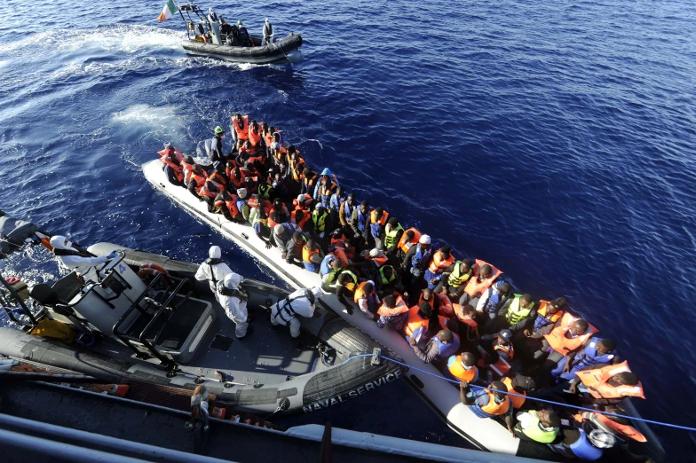 a group of people standing on the back of a boat