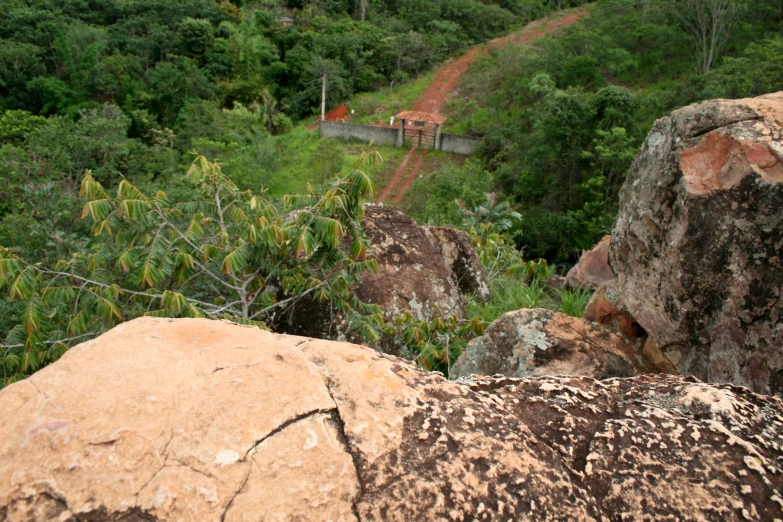 rocky terrain and dirt path with trees at the top