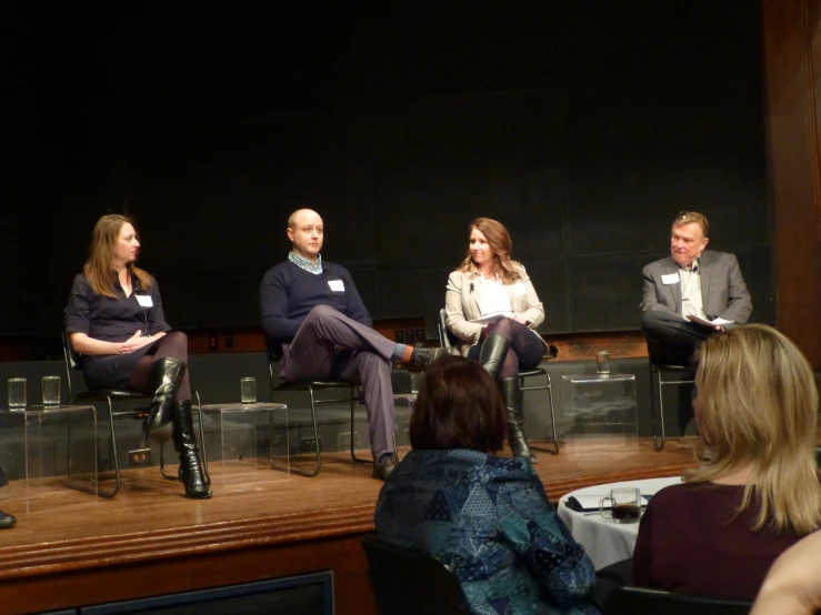 four people sitting down during a discussion