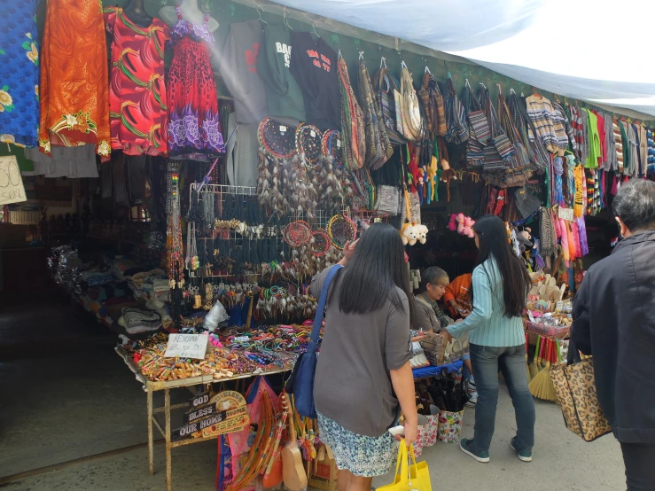 a small group of people standing at a market