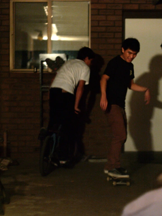 a group of boys standing around a skateboard