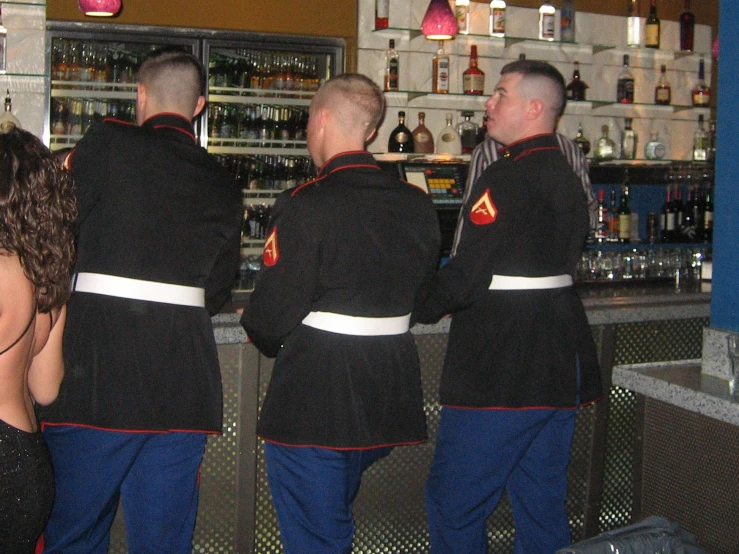 a group of people standing near the bar