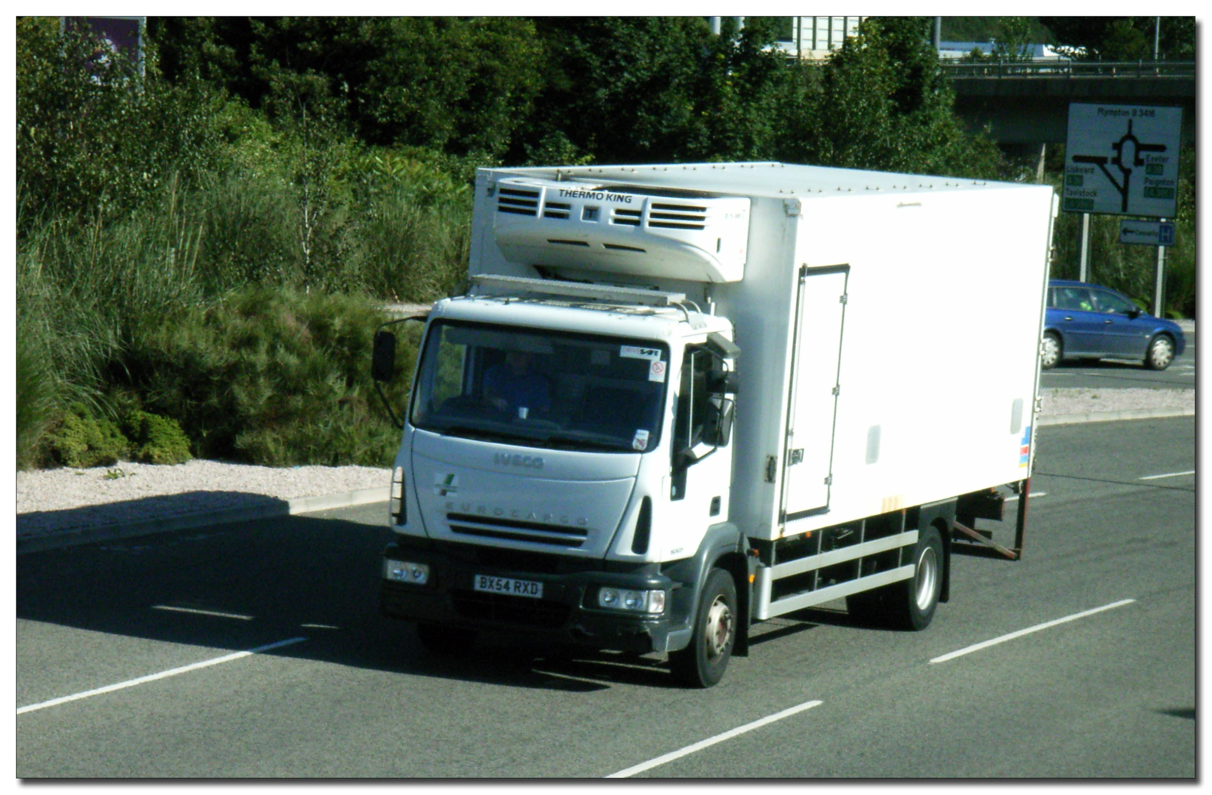 a truck on the road has been stopped at traffic lights