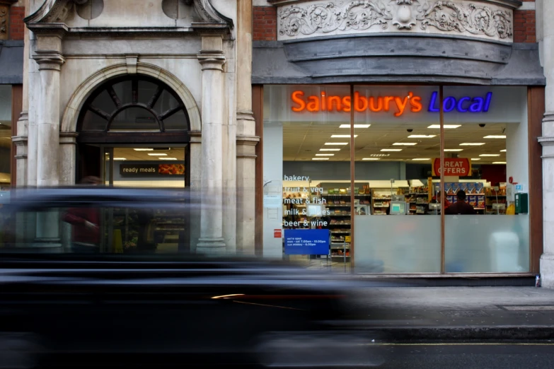 a blurry s of a store front and a street