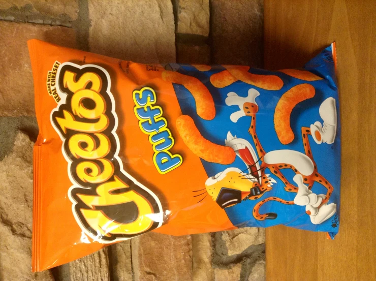 a bag of cheetos puffes sits on a table