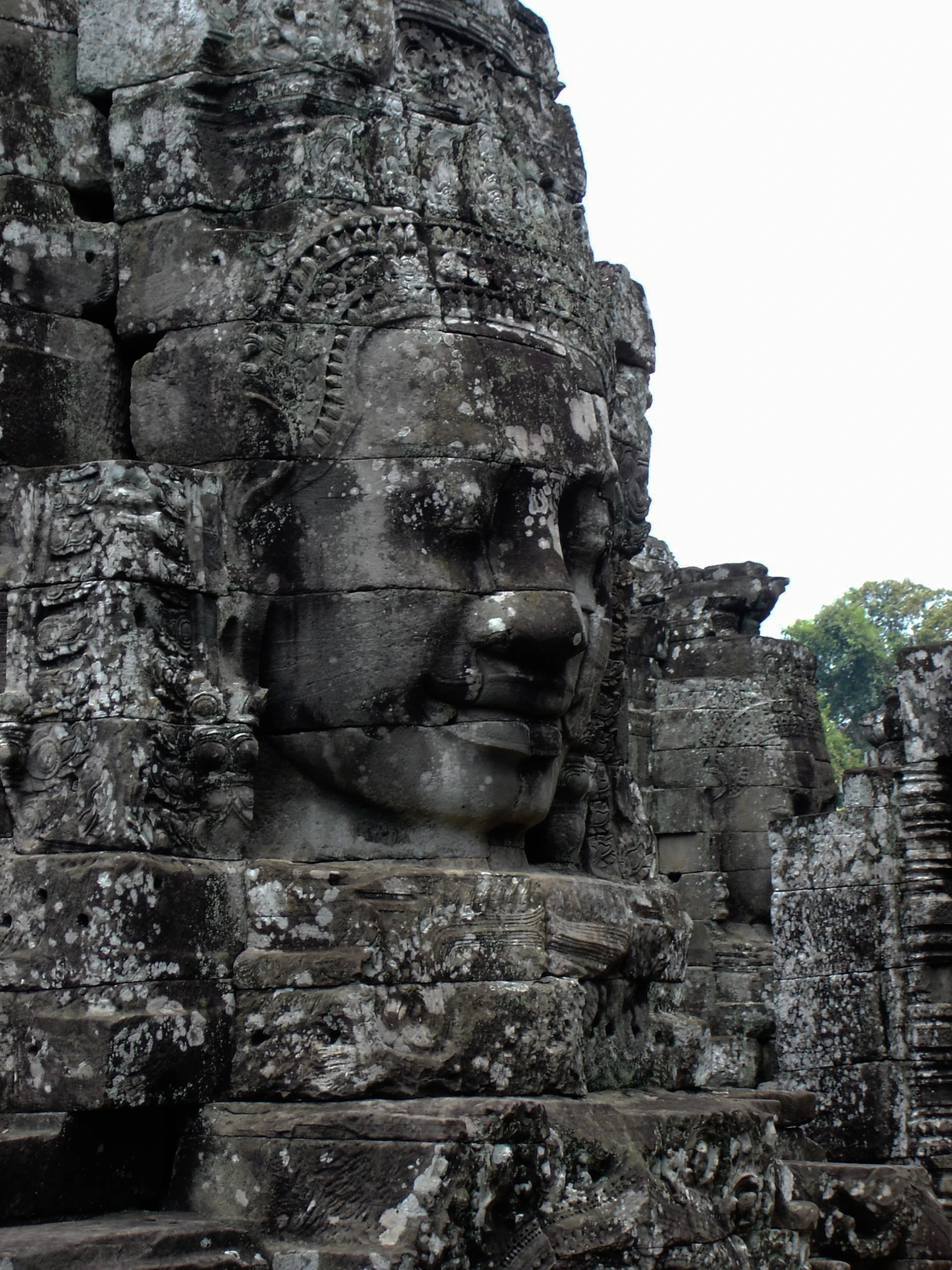a large, intricate statue on top of an ancient stone face
