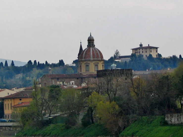 a church sits on a hill surrounded by trees