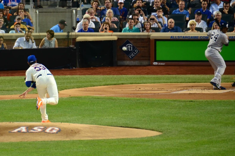 a baseball player pitching a ball during a game