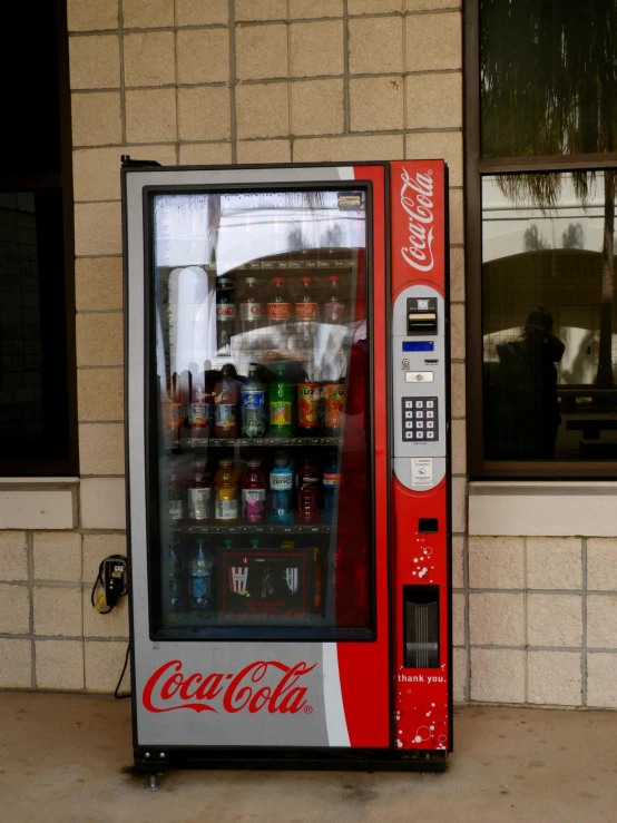 an old fashioned soda machine on the side of a building