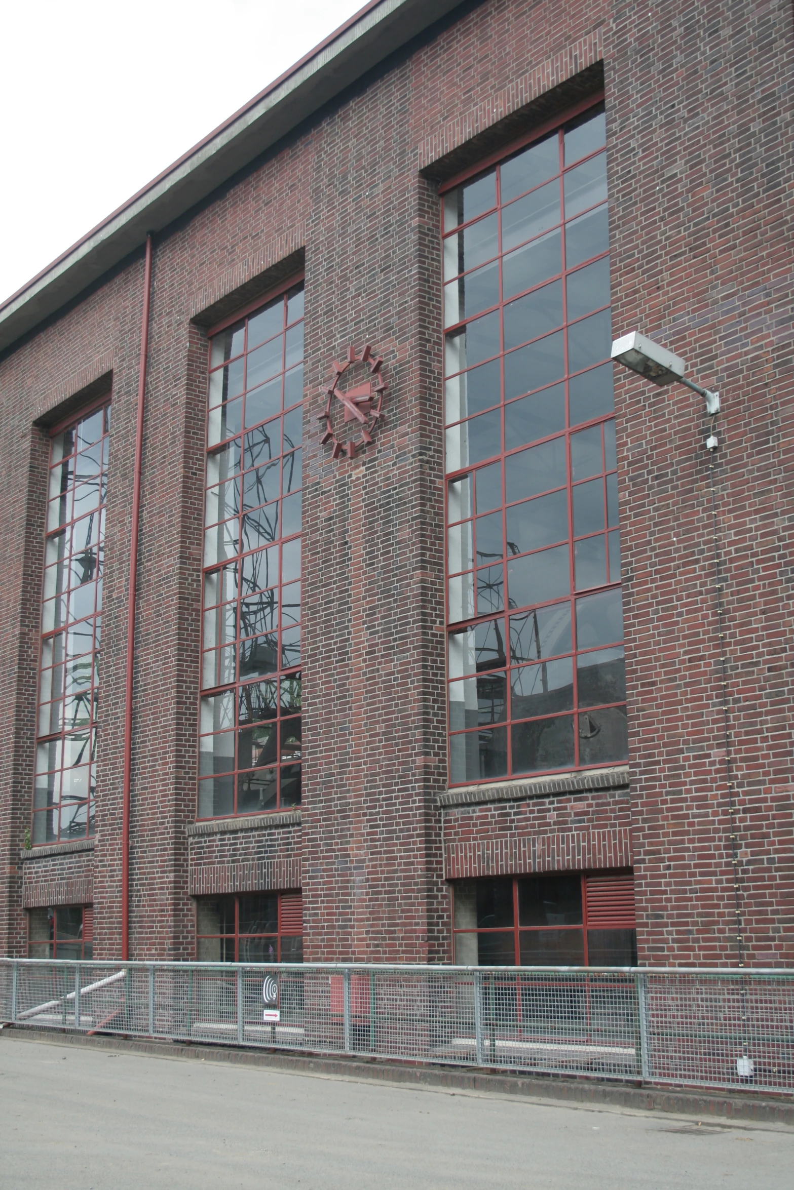 a red brick building with several windows and a clock