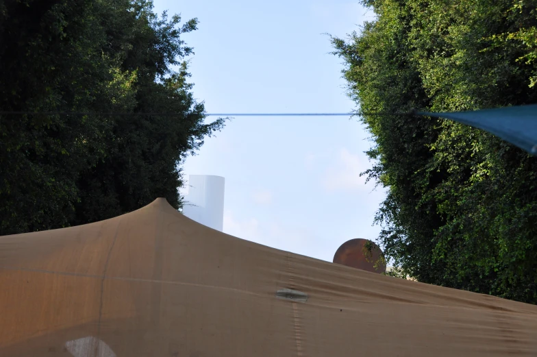 the large sheet on the umbrella has a small patch of light brown fabric covering it