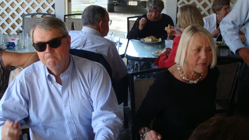 a couple sitting next to each other eating at a restaurant