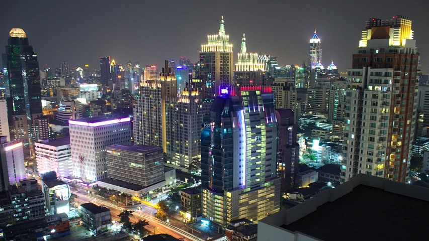 a night time view of a very tall city