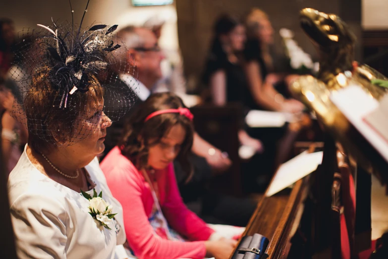 a woman is sitting next to a woman at a ceremony