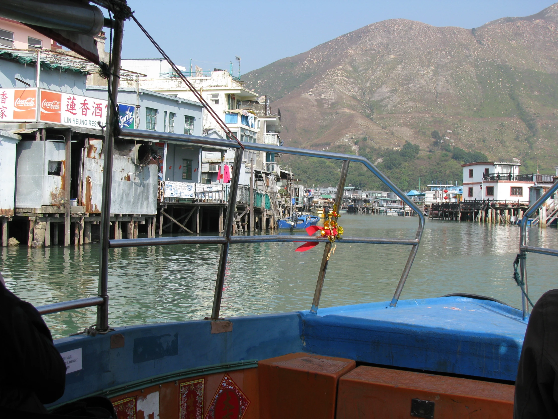 a boat is sitting on the water near several houses