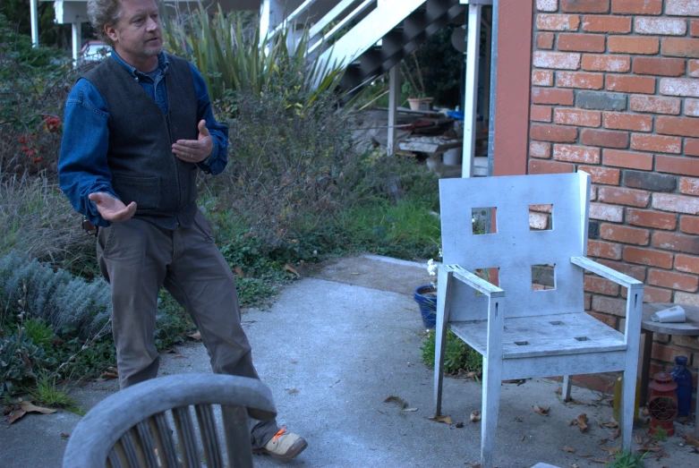 the man is standing in front of a chair