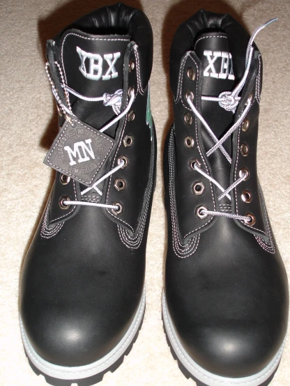 closeup of a pair of black boots with a logo